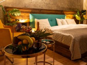 a bedroom with a bed and a table with a bowl of fruit at Boutique 17B in Sibiu +92 photos