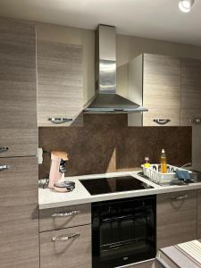 uma cozinha com um lavatório e um fogão forno superior em Les petits nids de Nina 3 em Fosses-La-Ville