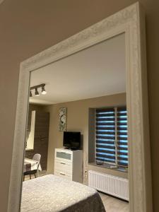 a mirror in a room with a bedroom at Les petits nids de Nina 3 in Fosses-La-Ville