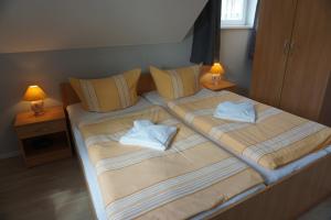 a bedroom with two beds with towels on them at Maisonetten Apartment in Rheinsberg