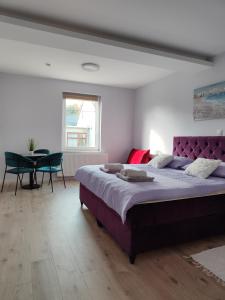 a bedroom with a large bed and a table at Villa Vino & Grad in Zagreb