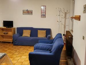 a blue couch and chairs in a living room at Appartamenti Bice Abetone in Abetone