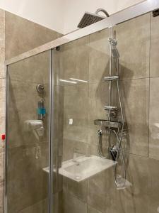 a shower with a glass door and a sink at Toledo Point in Naples