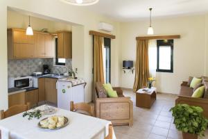 a kitchen and a living room with a table in a room at Xenios Zeus Apartments in Kissamos