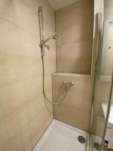 a shower with a glass door in a bathroom at Möblierte Wohnung Hannover List in Hannover