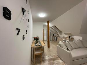 a living room with a couch and a table at Taverna Apartman in Monor