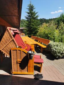 a group of picnic tables and benches with a trash can at Olimpijka Lidia Wrzesinska in Więcbork