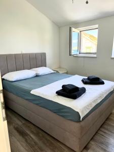 a bedroom with a bed with two towels on it at Novo uređeni apartman sa velikom terasom in Vis