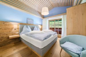 a bedroom with a bed and a blue ceiling at Appartement Ferienhof Ortnergut in Eben im Pongau