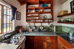 a kitchen with a stove and a counter top at Sweet little cottage at Lake La Laguna in San Pedro La Laguna