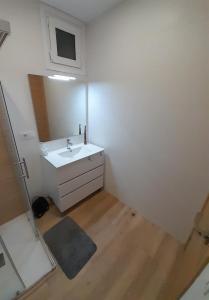 a bathroom with a white sink and a mirror at Casa MENDEZ - ALLARIZ in Ourense