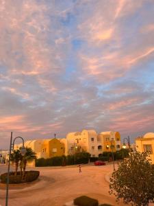 a group of buildings under a cloudy sky at Makady heights in Hurghada