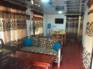 a living room with a couch and a table at LLT budget room WILPATTU in Nochchiyagama