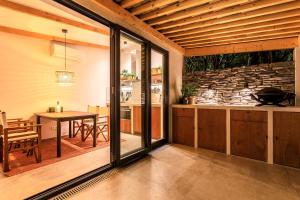 a kitchen and dining room with a stone wall at La Picolla Bellezza in Mandelieu-la-Napoule