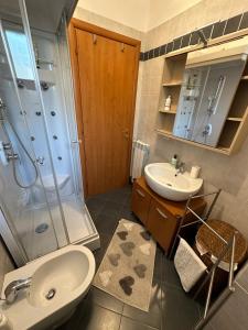 a bathroom with a sink and a shower and a toilet at Suite Tania in Fregene