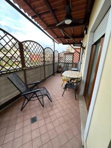 a balcony with two chairs and a table on it at Suite Tania in Fregene