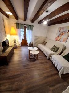 a living room with a couch and a table at La petite ferme in La Chapelle