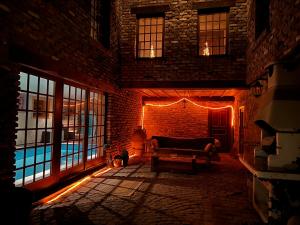 a dark living room with a couch and a pool at Le Têli du loup in Stavelot
