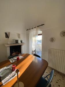 a dining room with a wooden table and a fireplace at B&B San Nicola in Pretoro