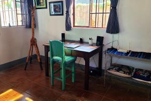 a room with a desk with a chair and a giraffe at Sweet little cottage at Lake La Laguna in San Pedro La Laguna