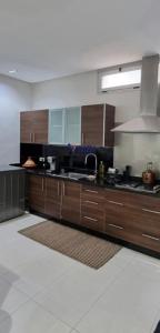 a large kitchen with wooden cabinets and a stove at Tangier Mediterranean Villa in Tangier