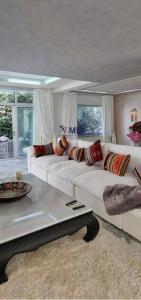 a living room with a white couch and a table at Tangier Mediterranean Villa in Tangier