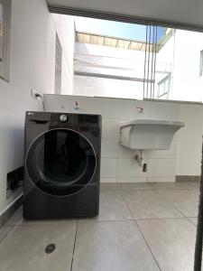 y baño con lavabo y lavadora. en Apartment 4 Rent - Av San Borja Sur Cdra 4, en Lima