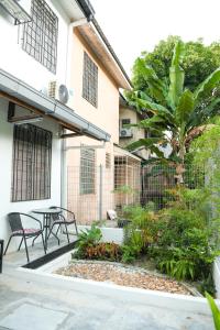 a courtyard of a building with a table and chairs at Homestay Dsunway in Petaling Jaya