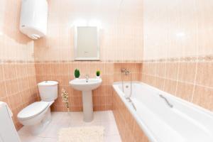 a bathroom with a toilet and a sink and a tub at Европейская 17 Мост сити Центр in Dnipro