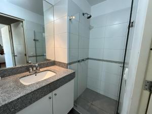 y baño con lavabo y ducha acristalada. en Apartment 4 Rent - Av San Borja Sur Cdra 4, en Lima