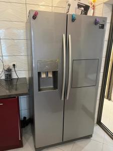 a stainless steel refrigerator in a kitchen next to a counter at Villa takamelouer immo in Brazzaville