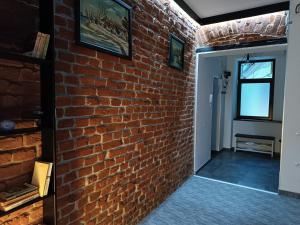 a brick wall in a room with a doorway at Apartament ultracentral in Oradea