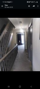 an empty hallway with a staircase in a building at Royal house in Ilkeston