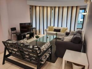 a living room with a couch and a tv at Lovely 3 bedroom Apartment in Nicosia center in Nicosia