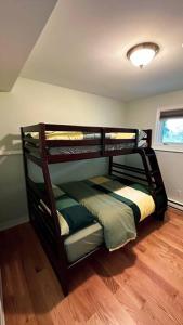 a bedroom with a bunk bed in a room at Entire house 3 min Drive to beach in Eastern Passage