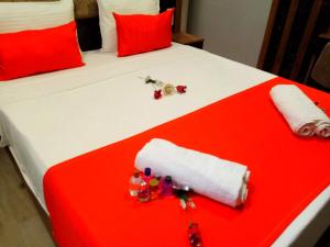 a bed with red and white sheets and red pillows at Roomsin Sultanahmet in Istanbul