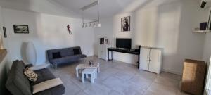 a living room with a couch and a table at La maison de Mamé in Arles