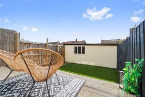 a patio with two chairs on a wooden deck at 3BD Retreat Boothstown Manchester in Ellenbrook