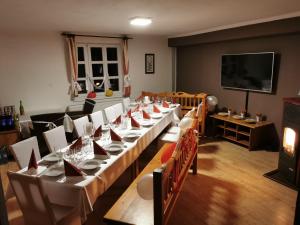 a dining room with a long table and chairs at Drevenica Spanka in Špania Dolina