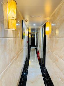 a hallway of a hotel with a fire hydrant at New International Guest House in Hong Kong