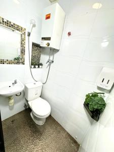 een badkamer met een toilet en een wastafel bij New International Guest House in Hong Kong