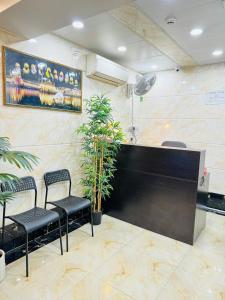 a waiting room with chairs and a large screen at New International Guest House in Hong Kong