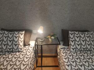 a room with two beds and a table with a lamp at Nice flat in Arrecife - perfect location in Arrecife +50 photos