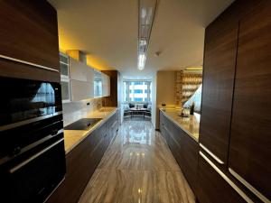 a large kitchen with wooden cabinets and a dining room at Amazing Apartment in the heart of Istanbul in Istanbul