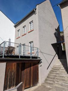 a building with a staircase next to a building at Ferienhaus MaLu Zell in Zell an der Mosel