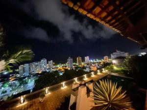 a view of a city at night with lights at Ampla, 180 graus de vista mar. in Ilhéus