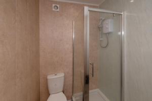 a bathroom with a shower and a toilet at Central Apartment Darlington in Darlington
