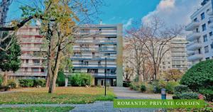 a large apartment building in a city with a park at Villa Diva - Villa Hestia Paris 16e in Boulogne-Billancourt