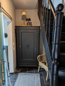 a staircase in a house with a black door at Ferienhaus MaLu Zell in Zell an der Mosel