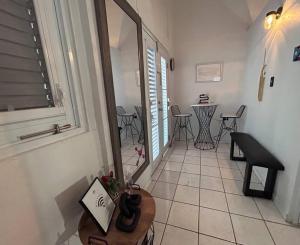 a room with a mirror and a table and chairs at City Dreams Cozy Loft in Guayama Great Location in Guayama